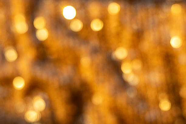Soft, out-of-focus golden lights form a warm, festive backdrop suitable for celebration, holiday, and seasonal themes.