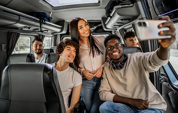 istock Diverse group of young students taking a selfie in bus 2245389676
