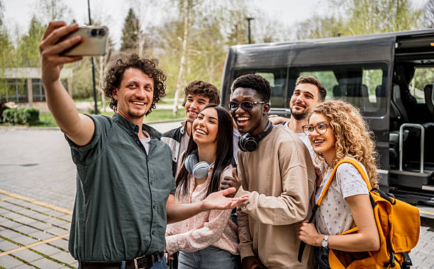 istock Diverse students taking selfie together before bus trip 2245390377