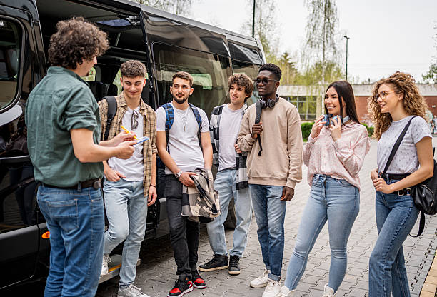 istock Group of diverse students talking before bus trip 2245390594