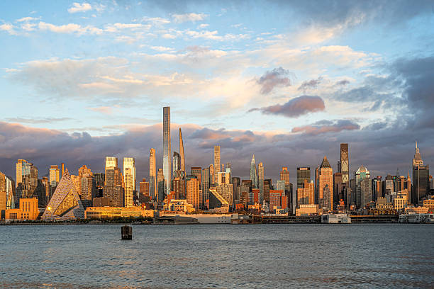 istock New York City skyline at sunset with dramatic clouds. 2245390638