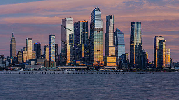 istock New York City skyline at sunset with colorful clouds. 2245390672