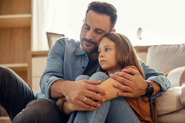 istock Father comforting sad daughter showing emotional support 2245390925