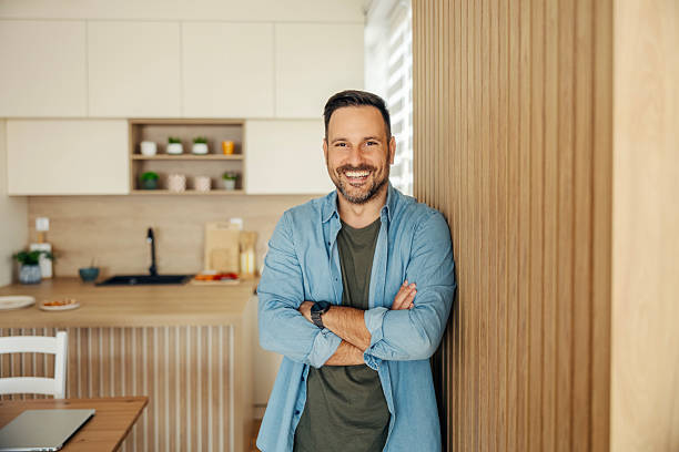 istock Man smiling with arms crossed in modern kitchen 2245390971