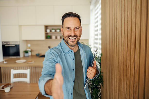 istock Happy man extending hand for handshake or welcome greeting 2245390984
