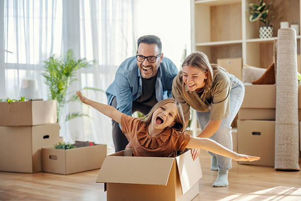 istock Family playing in cardboard box enjoying new home move 2245391083