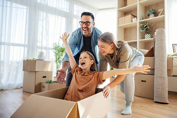 istock Family playing with moving box in new home 2245391090