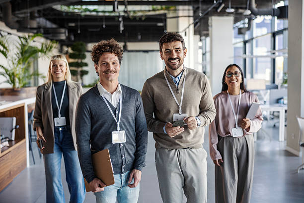 istock Diverse business team walking in modern office smiling 2245391468
