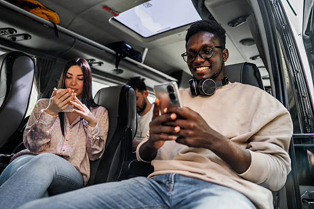 istock Young adult students traveling on bus using smartphone 2245391708
