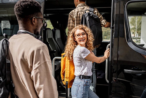 istock Young adults entering bus for group travel 2245391741