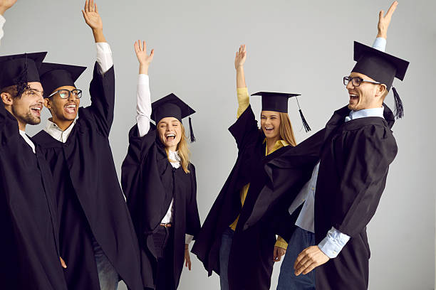 istock Group of happy university students celebrating graduation and having fun together 2245392491