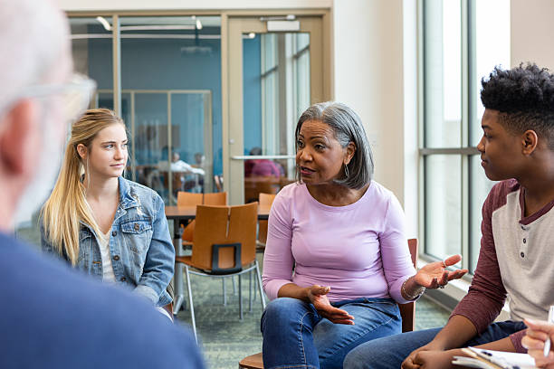 istock Diverse group of people engage in supportive conversation in a community setting 2245393224