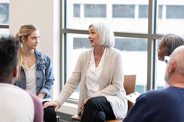 istock Diverse group participates in a supportive discussion session, facilitated by a professional. 2245393356