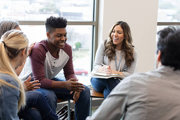 istock Diverse group of people engaged in positive and supportive discussion during a therapy session 2245393421