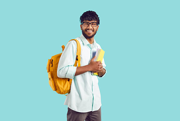 istock Smiling international male student with backpack and books 2245394181