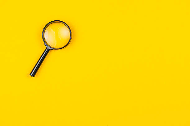 istock Magnifying glass on yellow background symbolizes curiosity and exploration 2245397934