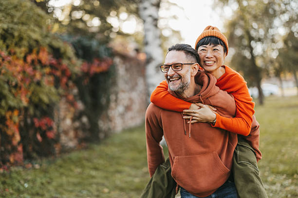 istock Cheerful multiracial couple having fun in autumn park 2245399332