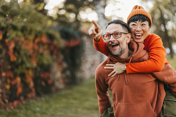istock Cheerful multiracial couple having fun in autumn park 2245399348