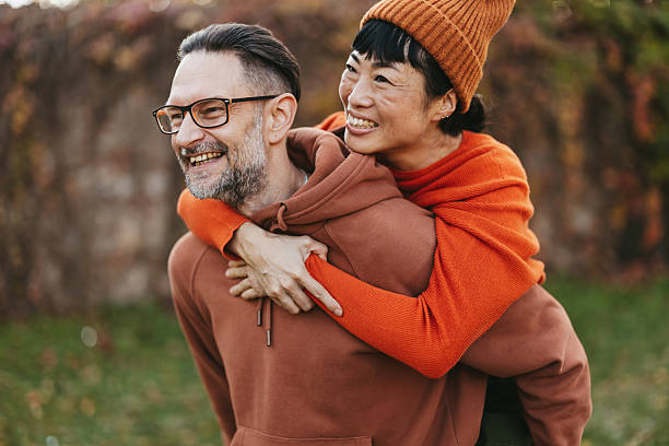 istock Cheerful multiracial couple having fun in autumn park 2245399528