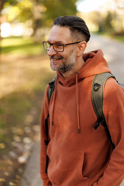 istock Mature man enjoying relaxing walk in autumn nature 2245399991