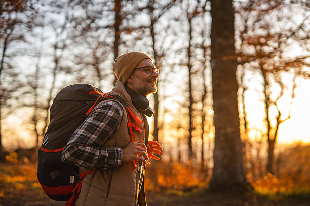istock Mature man hiking in autumn forest at sunset 2245400674