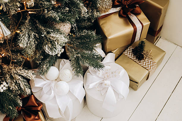 istock Festive Christmas tree with beautifully wrapped presents in cozy holiday setting 2245401876