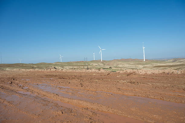 istock Muddy roads on the Gobi Desert, wind power turbines 2245402090