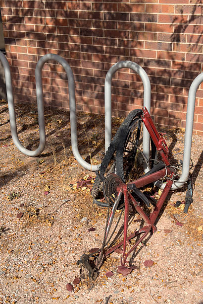 istock Abandoned broken bicycle frame chained to bike rack 2245402216