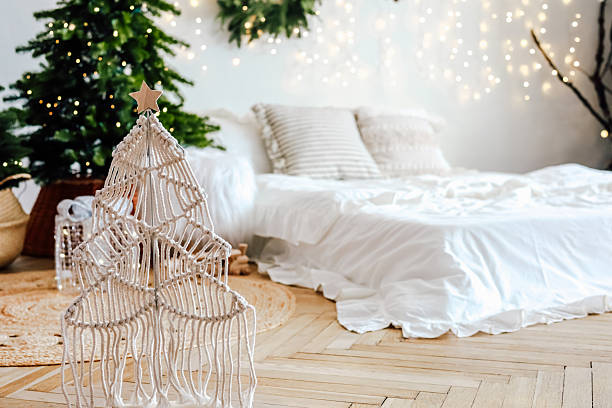 istock Decorative macrame Christmas tree in cozy holiday bedroom with lights and greenery 2245402320