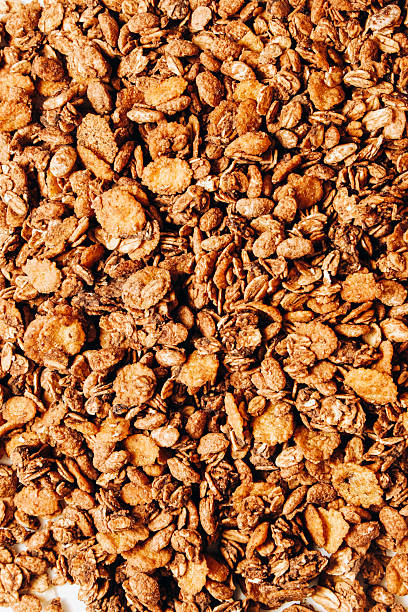 istock Crunchy granola mixture with oats and nuts on a white surface ready for breakfast 2245402540