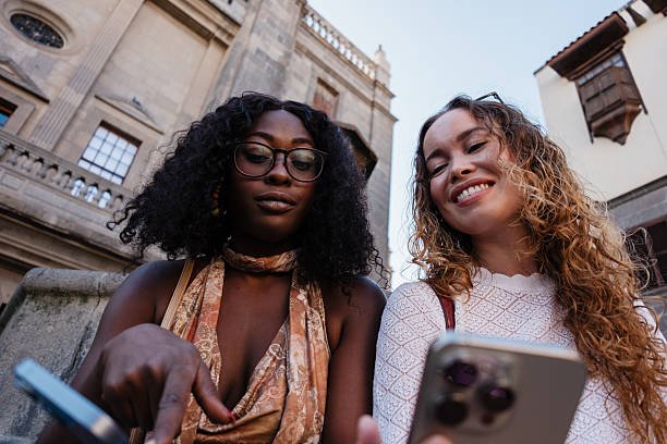 istock Diverse friends traveling looking at smartphone screen 2245404894