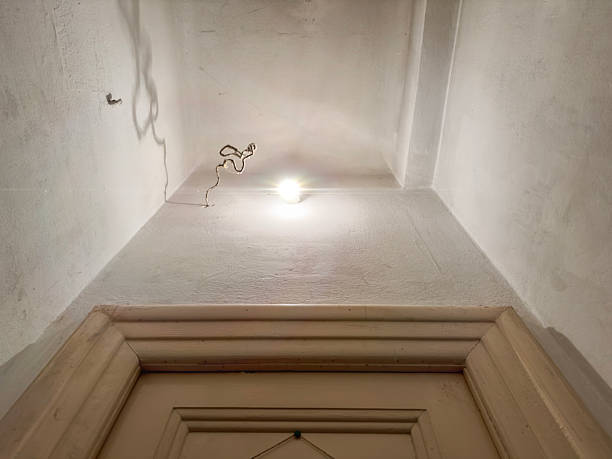 Bare Light Bulb and Exposed Wiring Above Old Door