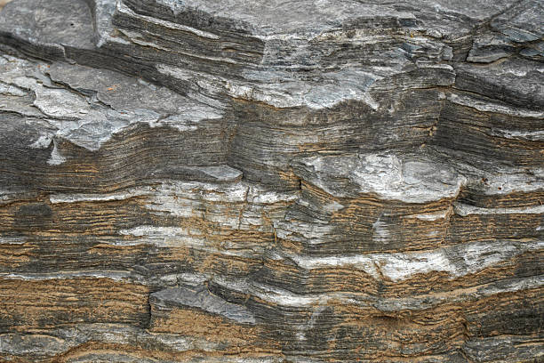 istock Close-up view of layered rock formation with various textures 2245414168