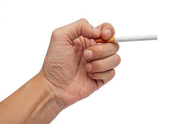 istock Hand holding unlit cigarette representing addiction and habit 2245419562