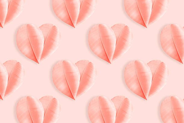 istock Pink hearts from fluffy feathers on pastel peach background. Minimal aesthetic pattern, symbol of love and romance, holiday greetings for Valentine Day, pink monochrome flat lay photo, top view layout 2245420331