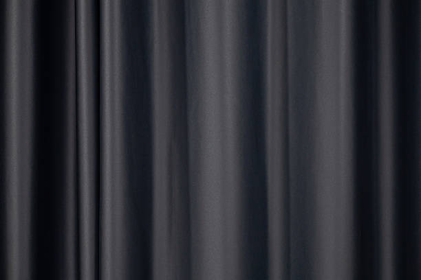 istock The black curtains are wavy, soft, smooth and shiny. 2245420583