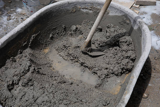 istock Mix tile glue or cement with an electric drill for repairs at construction sites. Waiting to mix with cement Construction worker or technician mixing cement in a bucket 2245420584