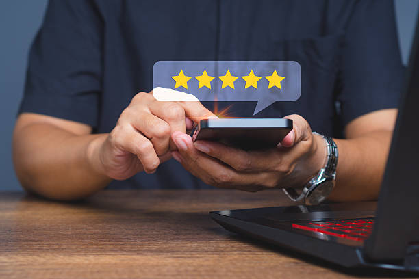 istock Customer giving five star rating on mobile phone for service review. 2245421444