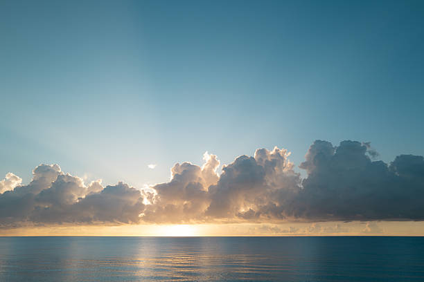 istock Sea sunset with cloudy sky and sun through the clouds over. Clouds Ocean and sky background, seascape. 2245422481