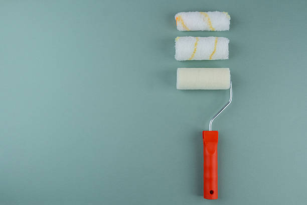 istock Three paint rollers on green background for painting variety and DIY concept 2245423550