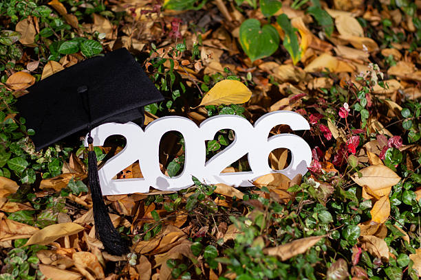 Graduation Cap and 2026 Sign Among Fallen Leaves in a Natural Setting