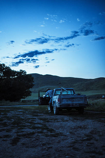 At first light, a rancher steps from his truck in open farmland, ready to start the day installing a solar-powered fence on his family ranch in Wyoming.