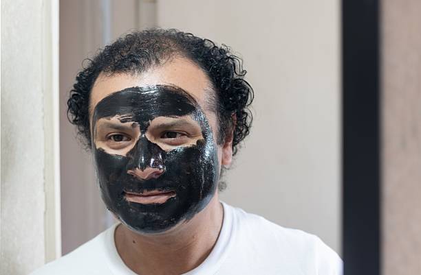 istock man wearing a face mask in the bathroom 2245429649