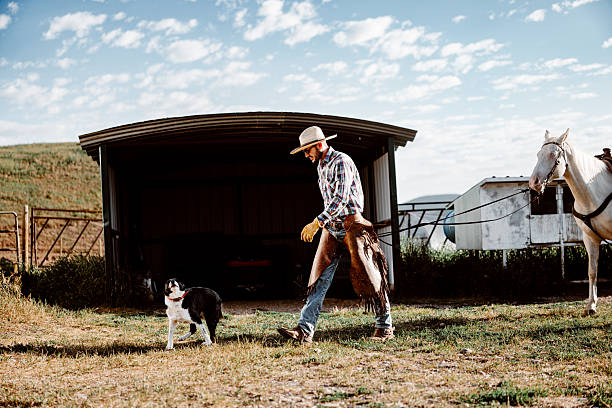 istock Rancher Walking with Herding Dog and Horse 2245429751
