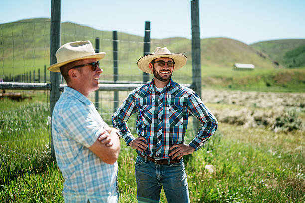 istock Brothers Talking in Field on Family Ranch 2245430401
