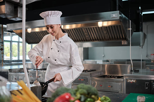 istock Female chef in white apron uniform cooking fried rice in restaurant kitchen. 2245430965