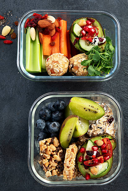 istock Bbox containing fresh fruits, vegetables, sandwiches, and nuts. 2245432201