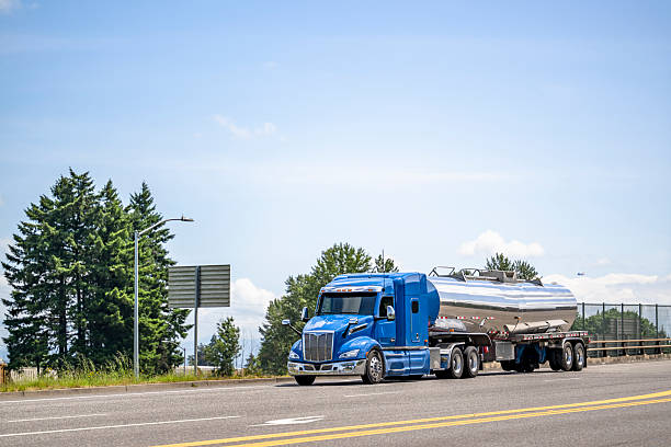 Tanker truck transporting liquid or gas by road  at sunset