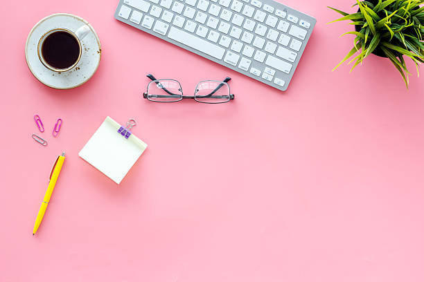 istock Home office workspace with computer keyboard and cup of coffee on pink background, top view. Education online. Tabletop of freelancer 2245435718