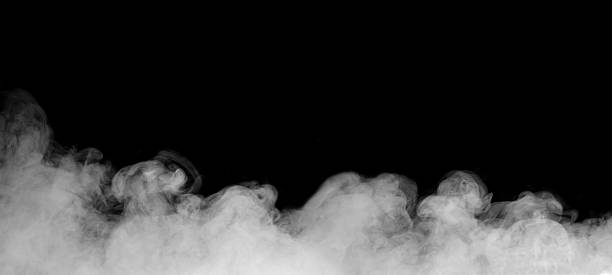 istock White smoke or fog drifting on black background, creating an abstract and atmospheric texture. Ideal for design overlays, video effects, or creative backgrounds in digital and cinematic projects. 2245438259